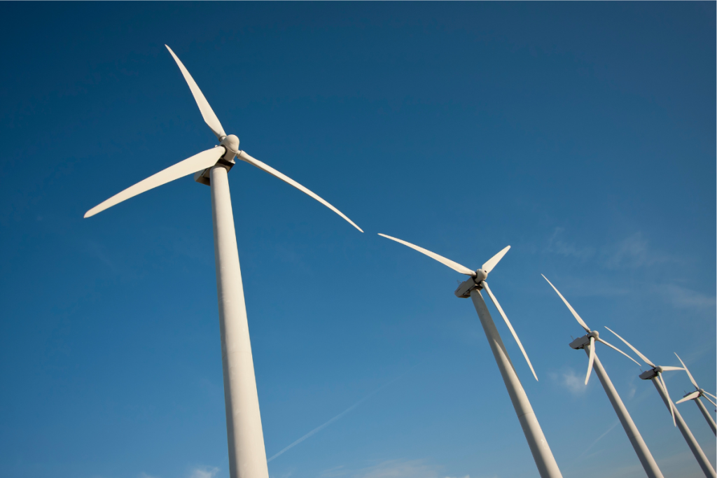 Wind turbines against a beautiful blue sky.