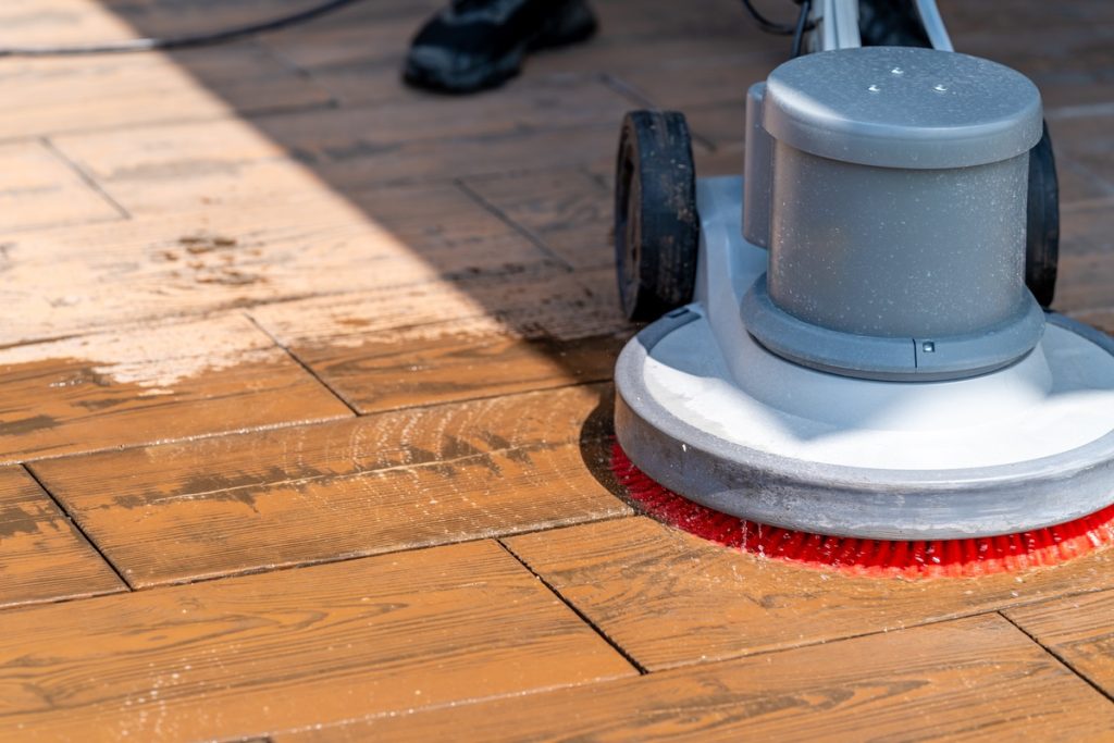 Professional cleaner buffing commercial floor