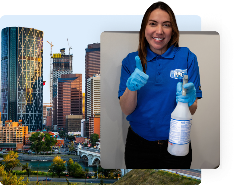 Smiling commercial cleaner from Picture Perfect Cleaning giving a thumbs-up while holding a disinfectant spray in Calgary or Edmonton.