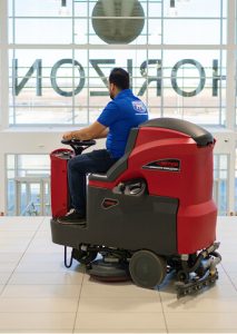 Picture Perfect Cleaning technician scrubbing a mall floor using a ride-on auto-scrubber in Calgary or Edmonton.