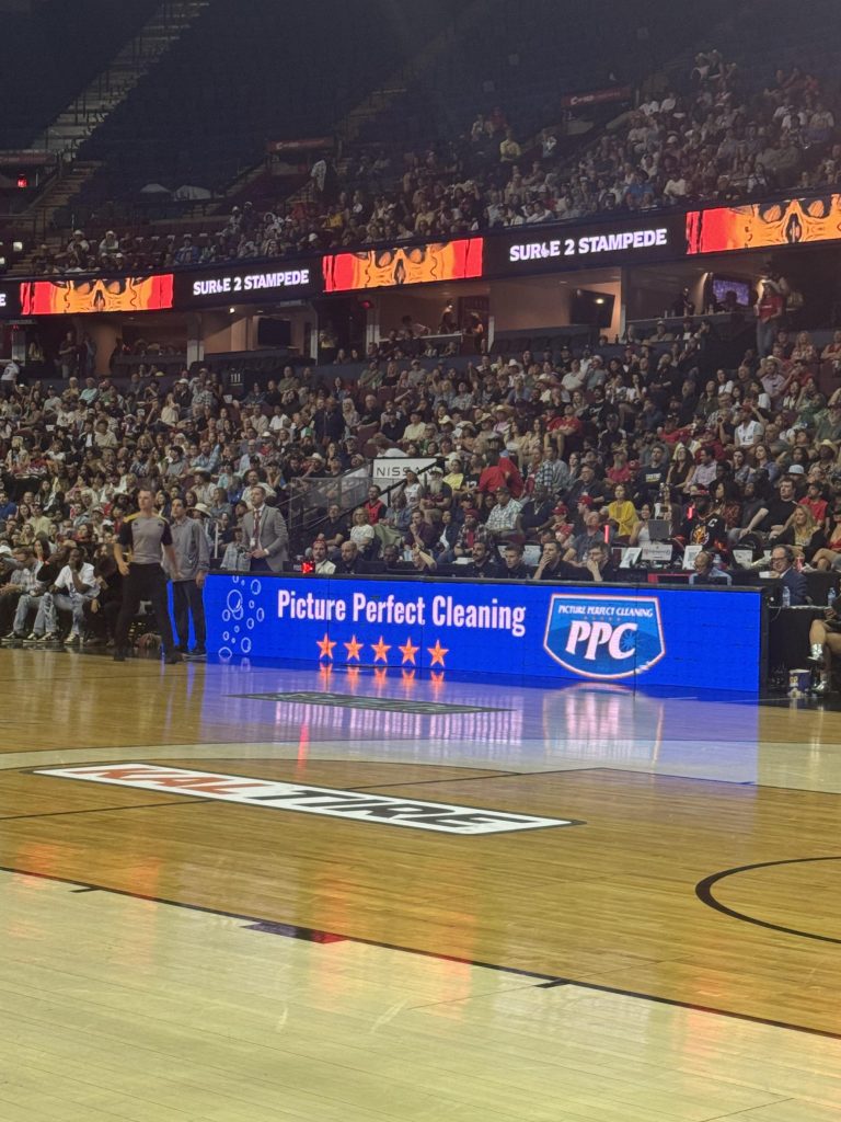 Picture Perfect Cleaning team attending the Calgary Surge basketball game during Stampede 2025 at the Scotiabank Saddledome.