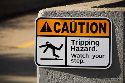 Sign calling out slip and fall risk at business site