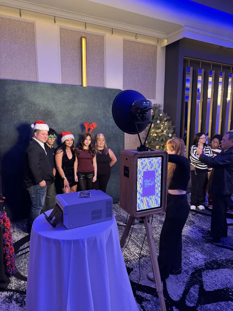 Guests posing with Christmas hats and props at the HipImage photo booth during the Picture Perfect Cleaning Christmas Party in Calgary